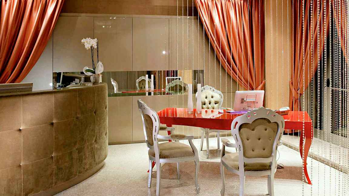 Et innbydende rom med et rødt bord, elegante møbler og dekorative elementer. (AI-generert tekst)