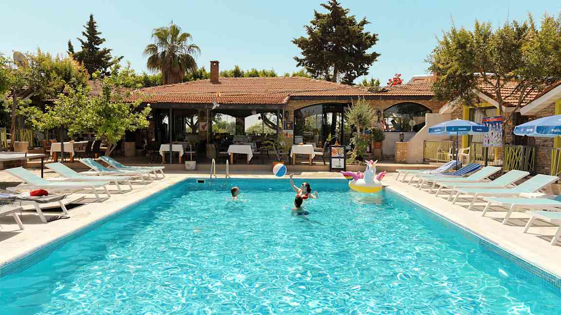 Utendørs svømmebasseng med mennesker som svømmer på et feriested. (AI-generert tekst)