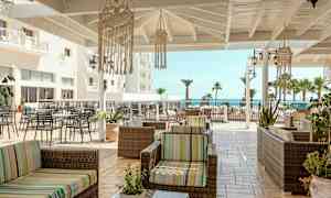 Terrasse med sittemøbler og utsikt mot havet. (AI-generert tekst)