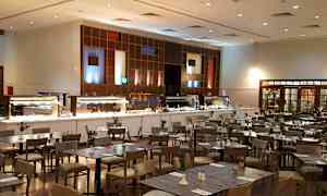 En restaurant med buffetområde og spisebord. (AI-generert tekst)