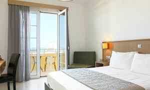 Et hotellrom med en dobbeltseng og en balkong med utsikt. (AI-generert tekst)