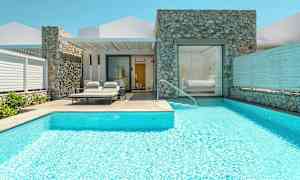 En villa med basseng og solsenger ved inngangen. (AI-generert tekst)