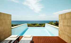 Et infinitybasseng med utsikt over havet. (AI-generert tekst)