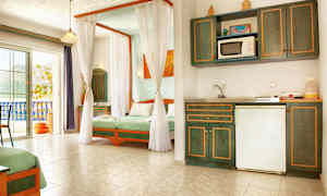 Et lyst hotellrom med kjøkkenkrok og senger med grønt sengetøy. (AI-generert tekst)