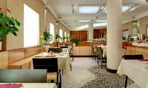 En moderne restaurant med oppsatte bord og blomster på hvert bord. (AI-generert tekst)