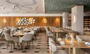 En elegant restaurant med trepaneler, smakfull dekor og dekkede bord. (AI-generert tekst)