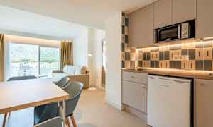 Moderne kjøkken og stue med utsikt mot balkong og fjell. (AI-generert tekst)