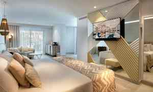 Moderne hotellrom med dobbeltseng, sittegruppe og TV. (AI-generert tekst)