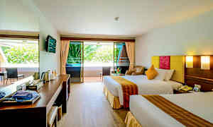 Hotellrom med to senger, sitteområde og balkong. (AI-generert tekst)