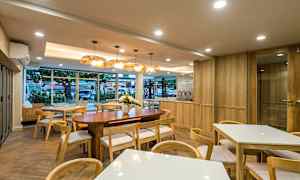 En moderne kafé med treinteriør og store vinduer. (AI-generert tekst)