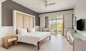 Hotellrom med en dobbeltseng, moderne innredning og en balkong med utsikt. (AI-generert tekst)