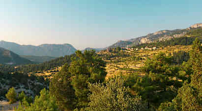 Et landskap med fjell og trær i forgrunnen. (AI-generert tekst)