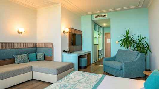 Et hotellrom med interiør i blå og beige toner, samt minimalistisk moderne design. (AI-generert tekst)