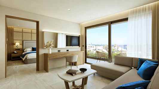 Et moderne hotellrom med stuedel, separat soverom og utsikt mot havet gjennom store vinduer. (AI-generert tekst)