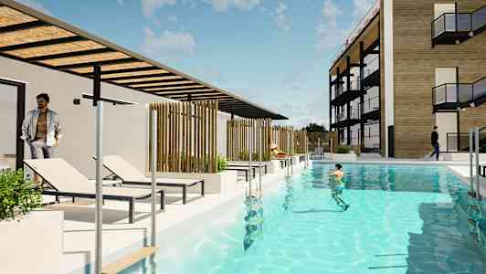 En moderne bygning med et basseng og solsenger i forgrunnen. (AI-generert tekst)