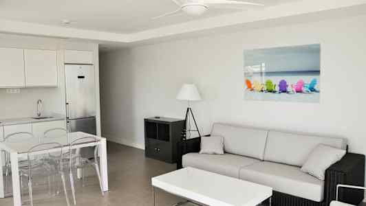 Moderne innredt stue med sofa, sofabord, spisebord og kjøkken. (AI-generert tekst)