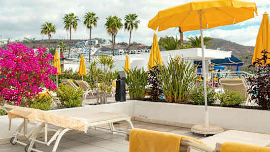 Solstoler og parasoller på en terrasse med utsikt. (AI-generert tekst)