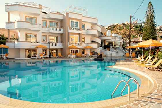 Bilde av et hotell med et basseng og solsenger foran bygningen. (AI-generert tekst)