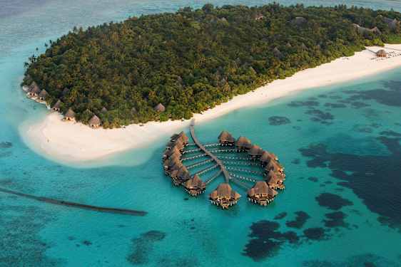 Luftfoto av en tropisk øy med hvite sandstrender og vannvillaer. (AI-generert tekst)