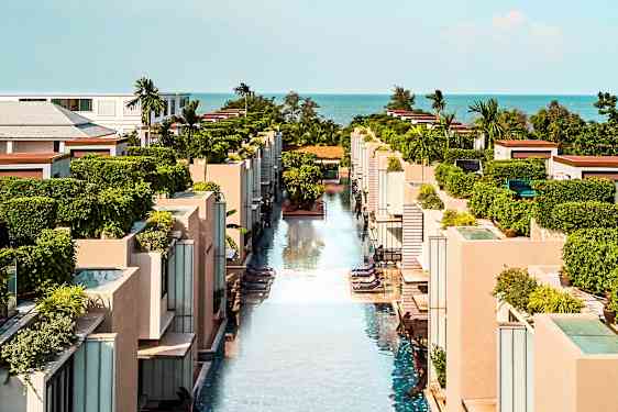 En utsikt over et moderne ferieanlegg med bassenger og grøntområder. (AI-generert tekst)