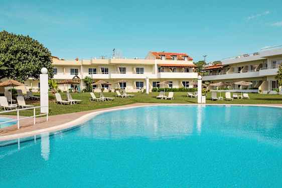 Bilde av hotellbygning med gressplen, parasoller, solsenger, og et stort basseng i forgrunnen. (AI-generert tekst)