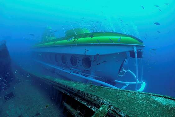Et undervannsbilde av en ubåt nær et skipsvrak, omgitt av fisk. (AI-generert tekst)