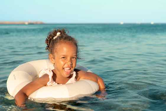 Jente koser seg og bader med badering