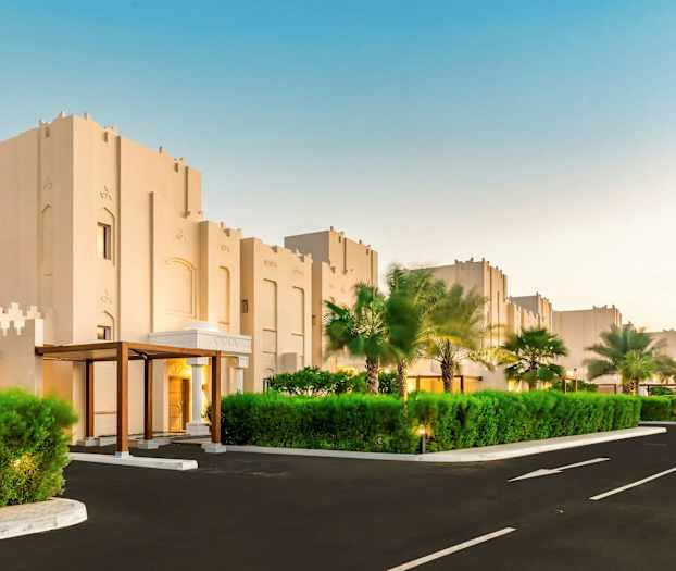 Bygninger med moderne arkitektur og omliggende grøntområder. (AI-generert tekst)