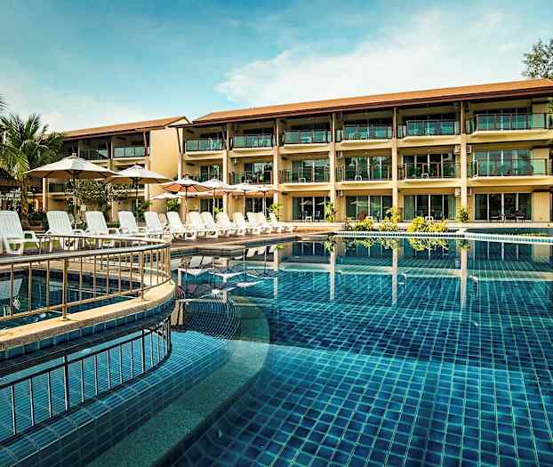 Et treetasjes hotell ved et basseng med solsenger og parasoller. (AI-generert tekst)