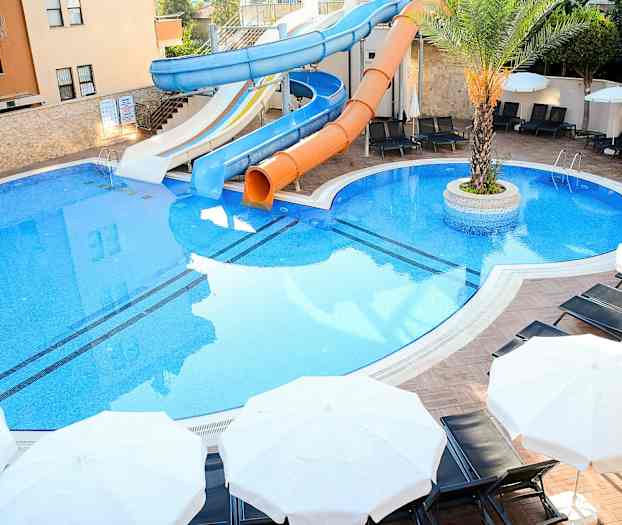 Bilde av et svømmebasseng med sklier og parasoller. (AI-generert tekst)