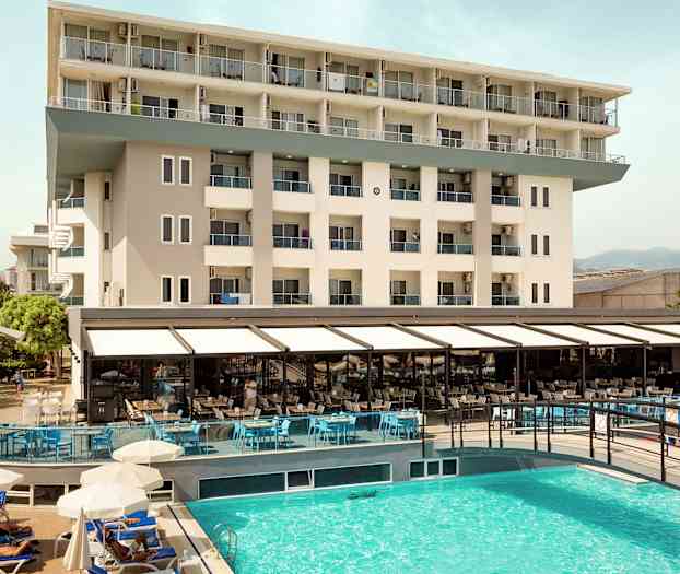 Utsikt over hotellbygning og utendørsbasseng. (AI-generert tekst)