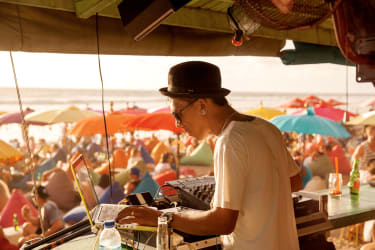 En DJ spiller musikk på stranda