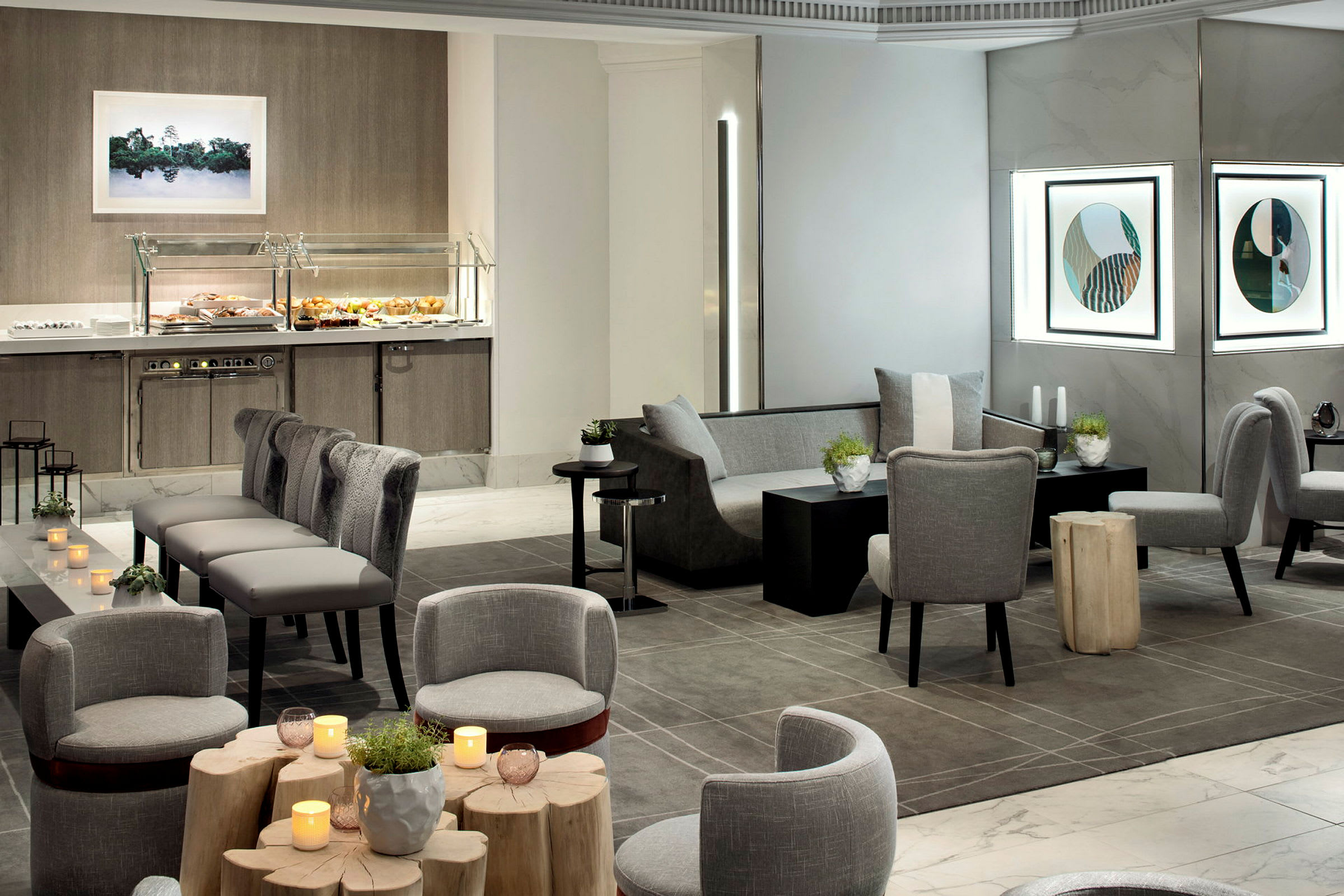 Et moderne hotellrom med sitteplasser, bord, dekorasjoner og en buffésseksjon. (AI-generert tekst)