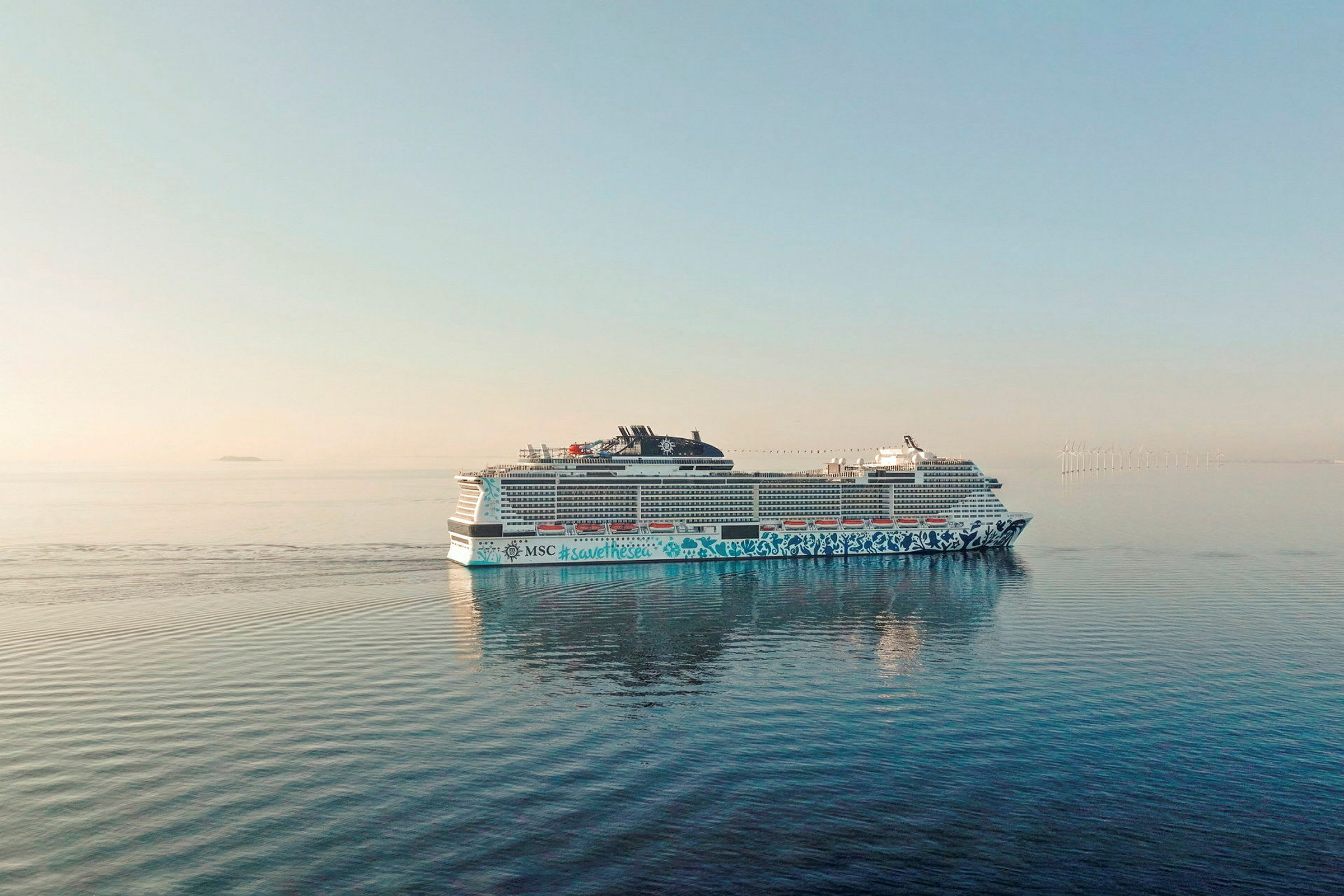 Et cruiseskip på åpent hav med vindmøller i det fjerne. (AI-generert tekst)