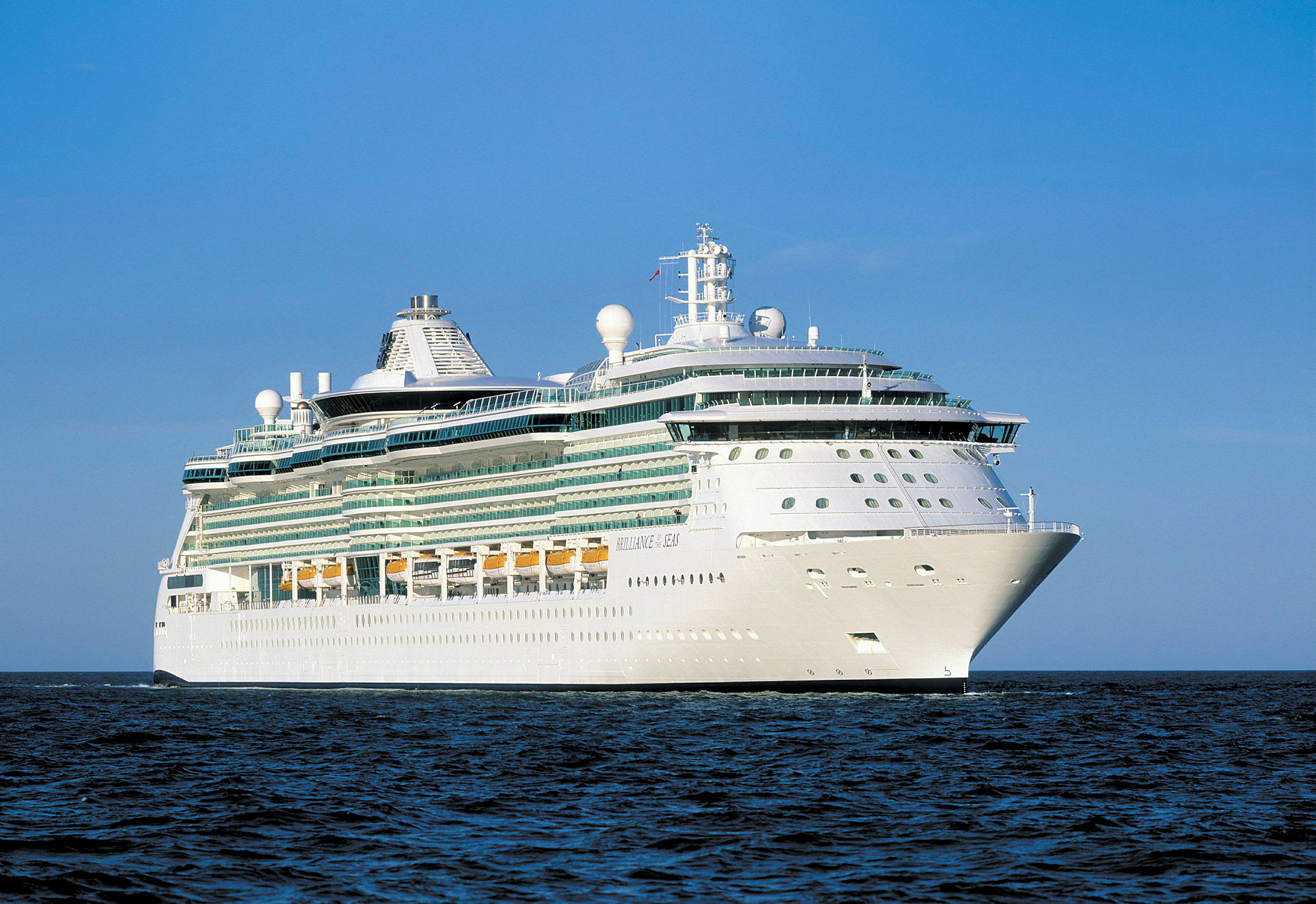 Et stort cruiseskip på havet under en klar blå himmel. (AI-generert tekst)