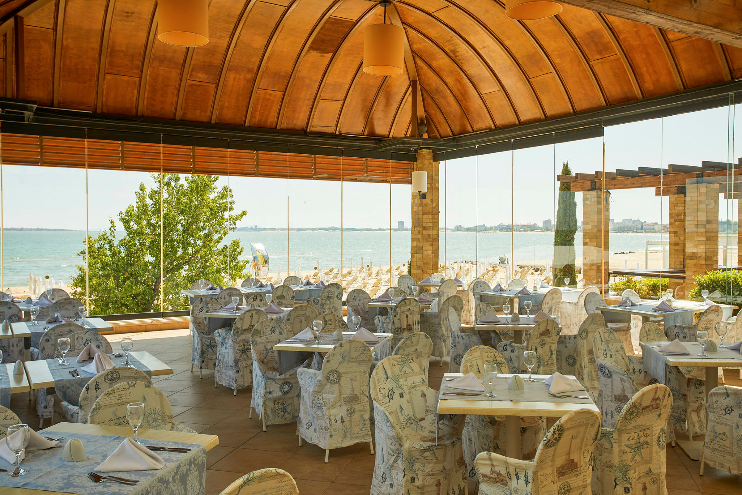 En restaurant med utsikt over en sandstrand og havet. (AI-generert tekst)