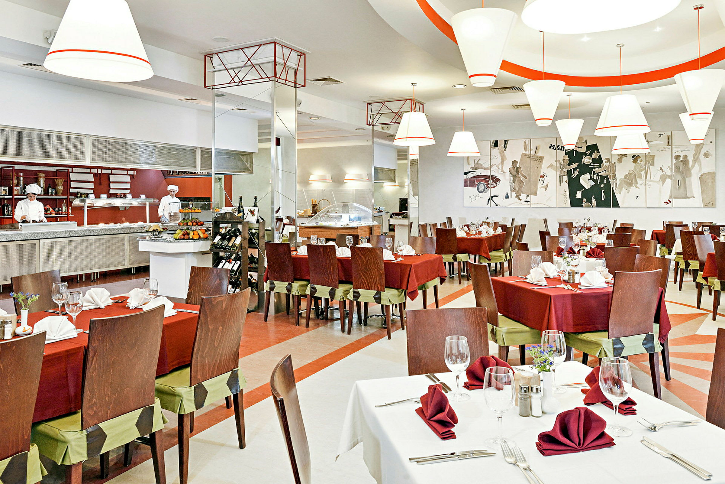 Bilde av en elegant restaurant med bord dekket med røde duker og servietter. I bakgrunnen er en åpen kjøkkenstasjon og kunstverk på veggen. (AI-generert tekst)