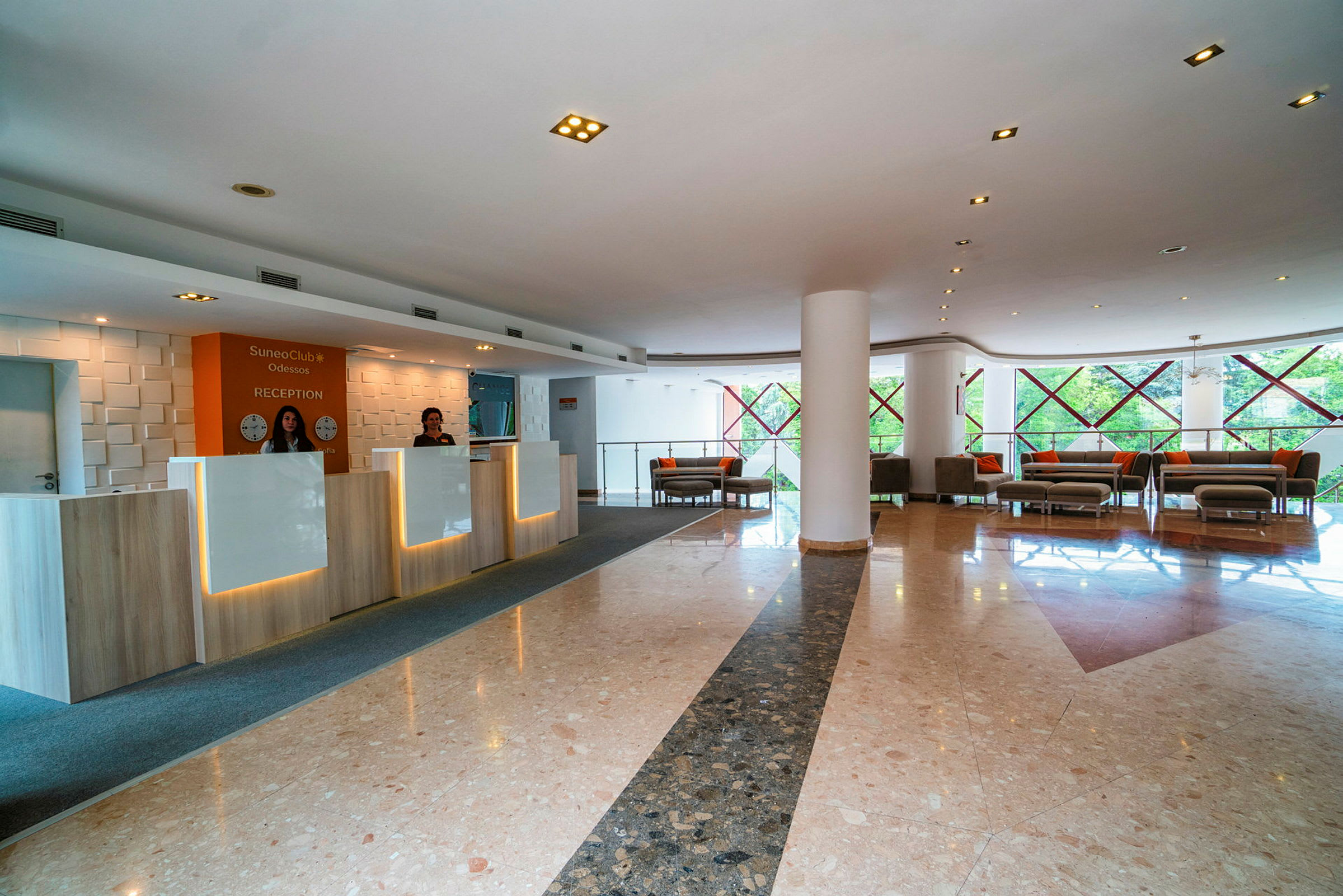 Hotellobby med resepsjon og sitteområder. (AI-generert tekst)