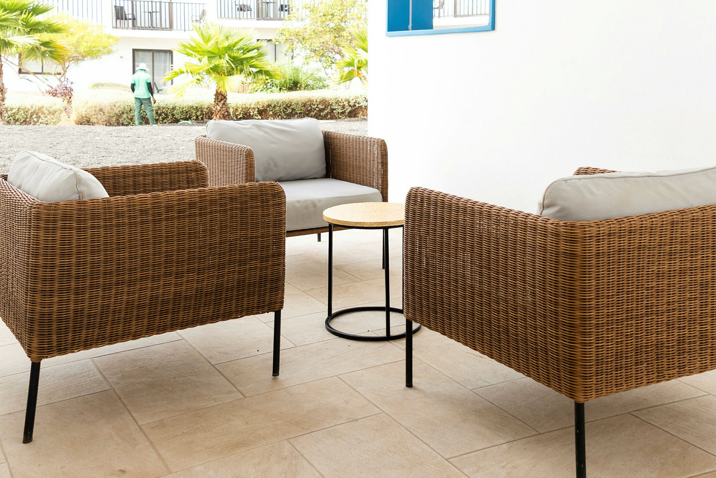 To rottingstoler med et lite bord mellom seg på en terrasse. (AI-generert tekst)