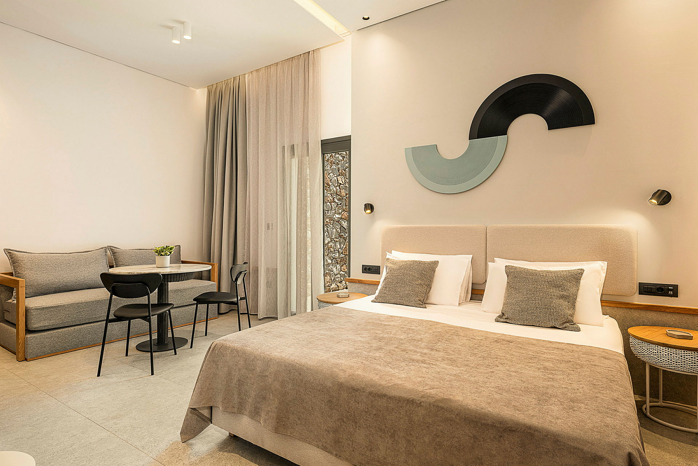 Moderne hotellrom med en dobbeltseng, sittegruppe og dekorative detaljer. (AI-generert tekst)