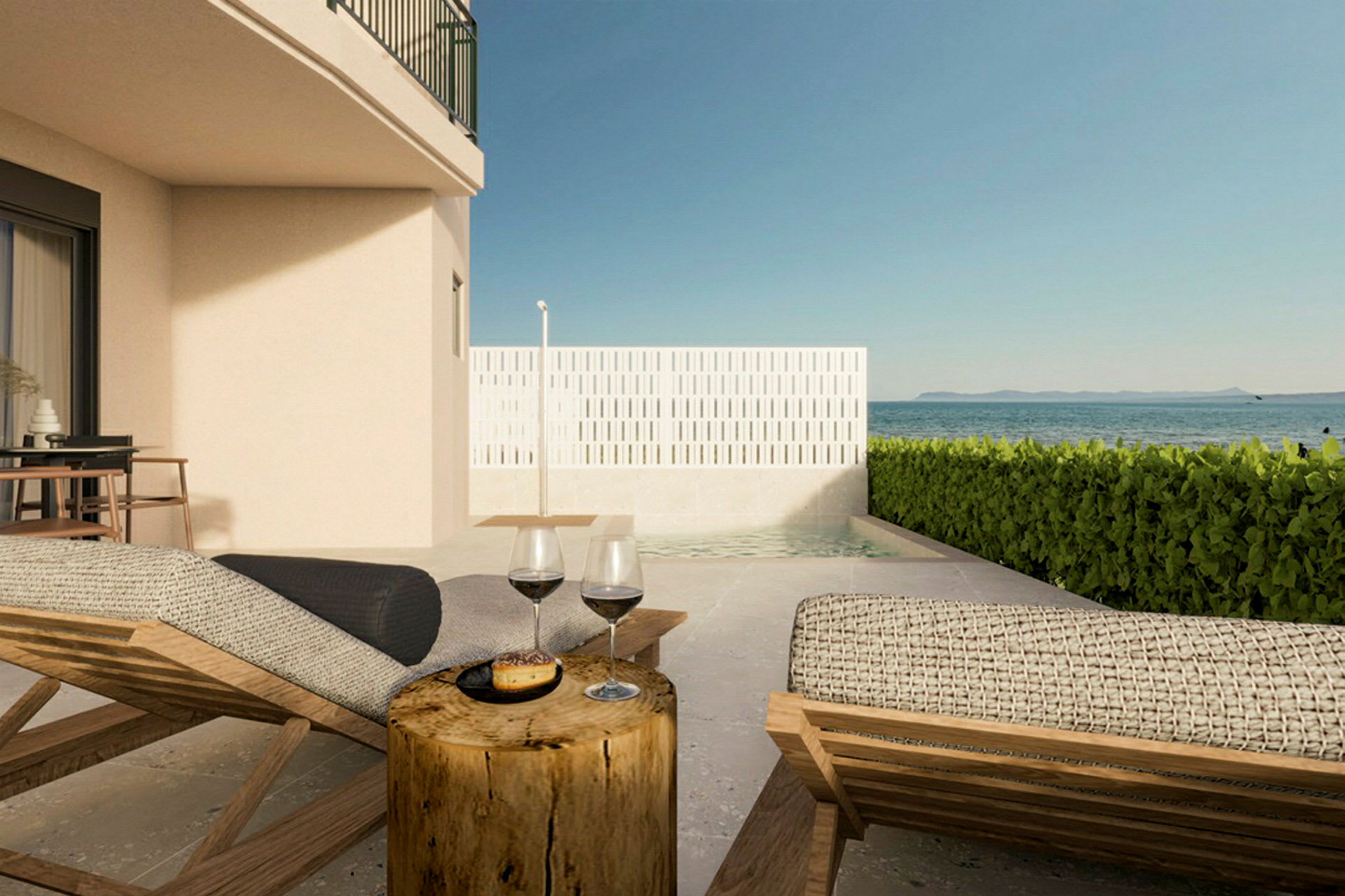 Bilde av en terrasse med solsenger, et bord med vinglass og utsikt over havet. (AI-generert tekst)