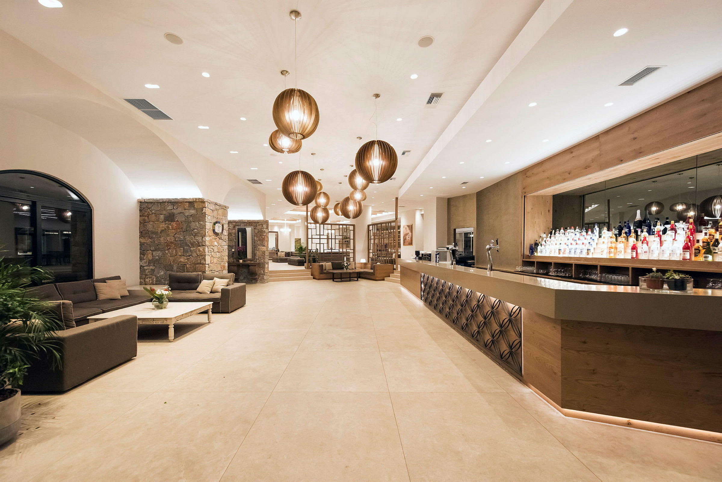 Moderne og godt opplyst hotellobby med sofaer og bardisk. (AI-generert tekst)