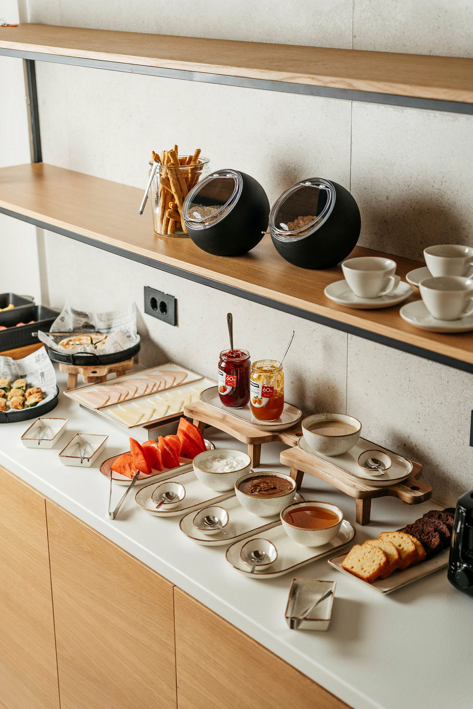 Frokostbuffé med brød, syltetøy og frukt. (AI-generert tekst)