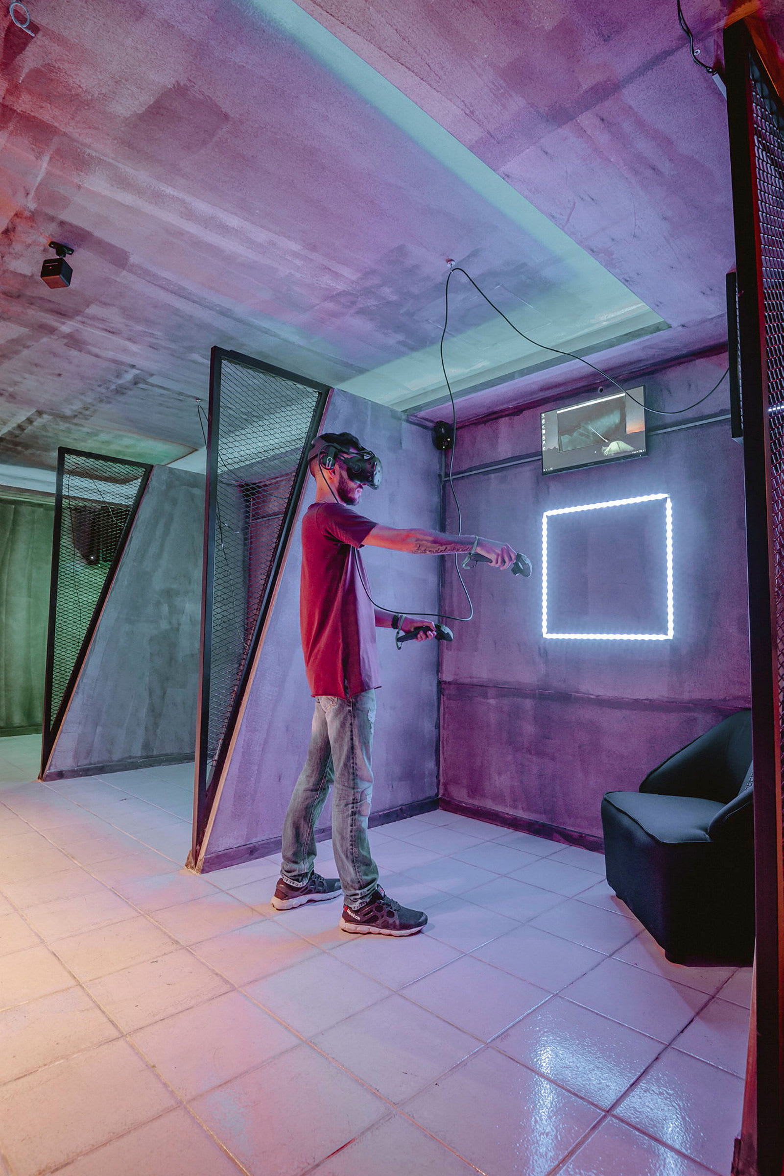 En person bruker VR-briller i et fargerikt rom med moderne interiør. (AI-generert tekst)
