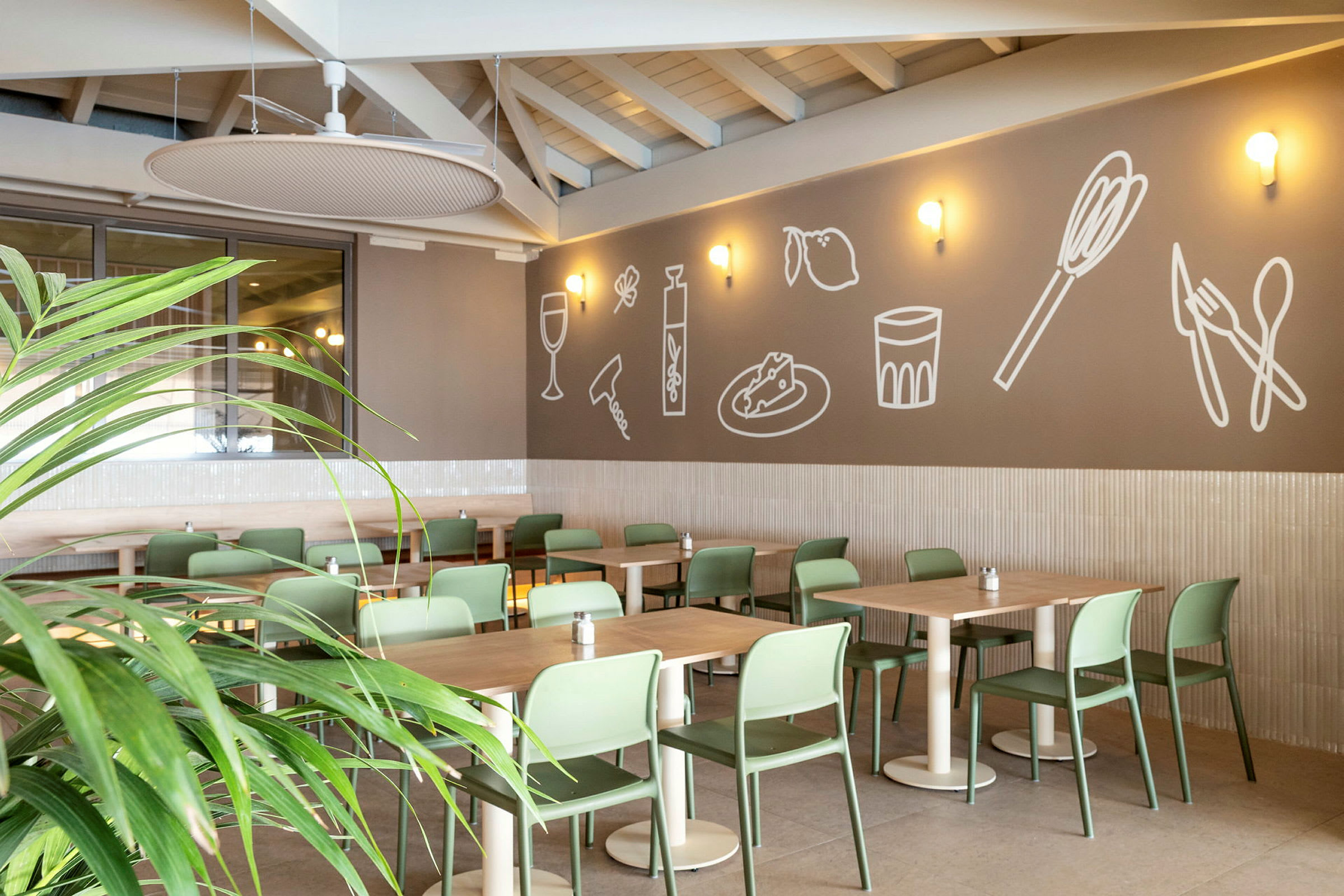 Restaurant med moderne grønne stoler og dekorert vegg. (AI-generert tekst)