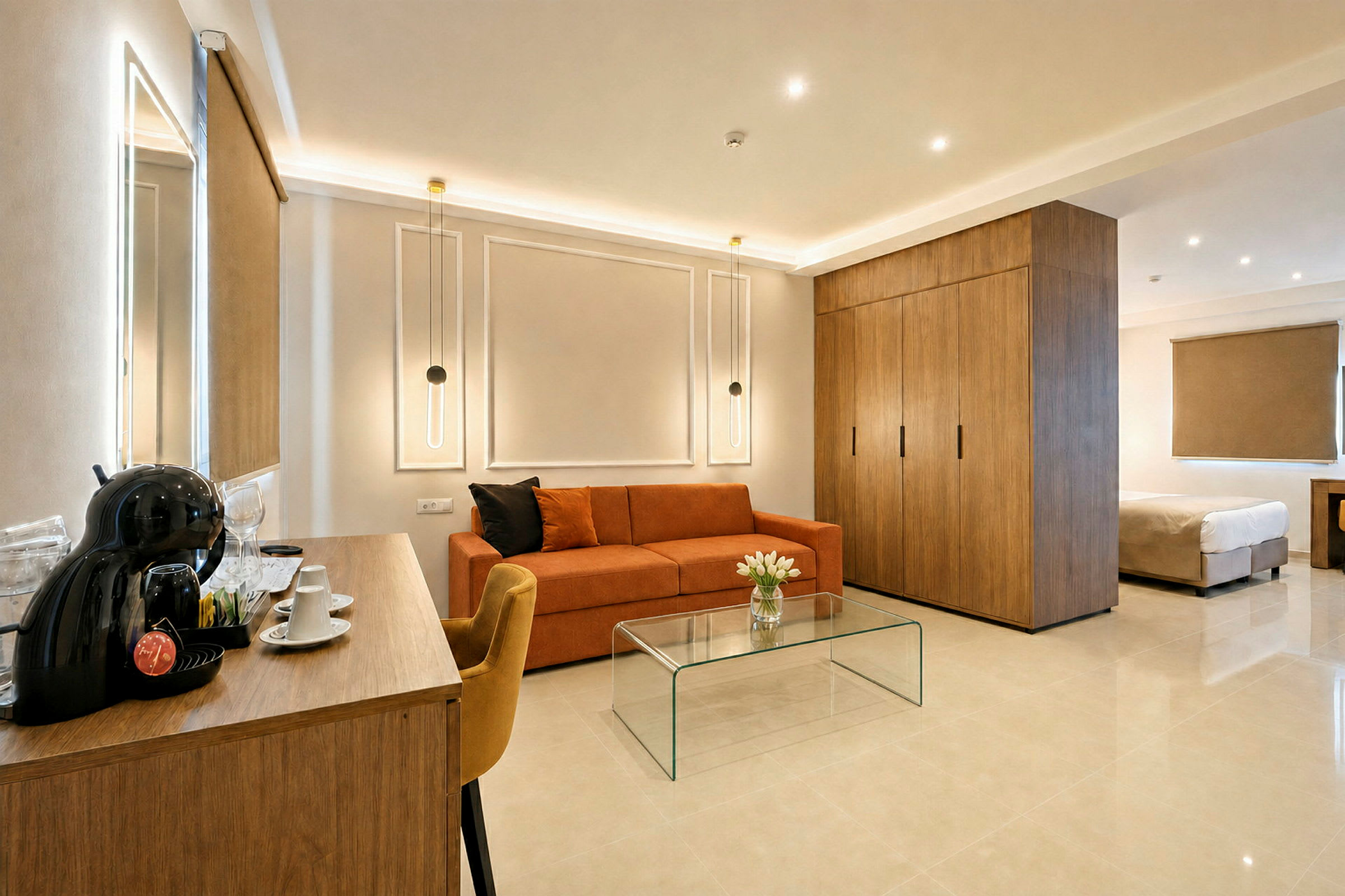 Et moderne hotellrom med en sofa, et glassbord, en garderobe og en seng. (AI-generert tekst)