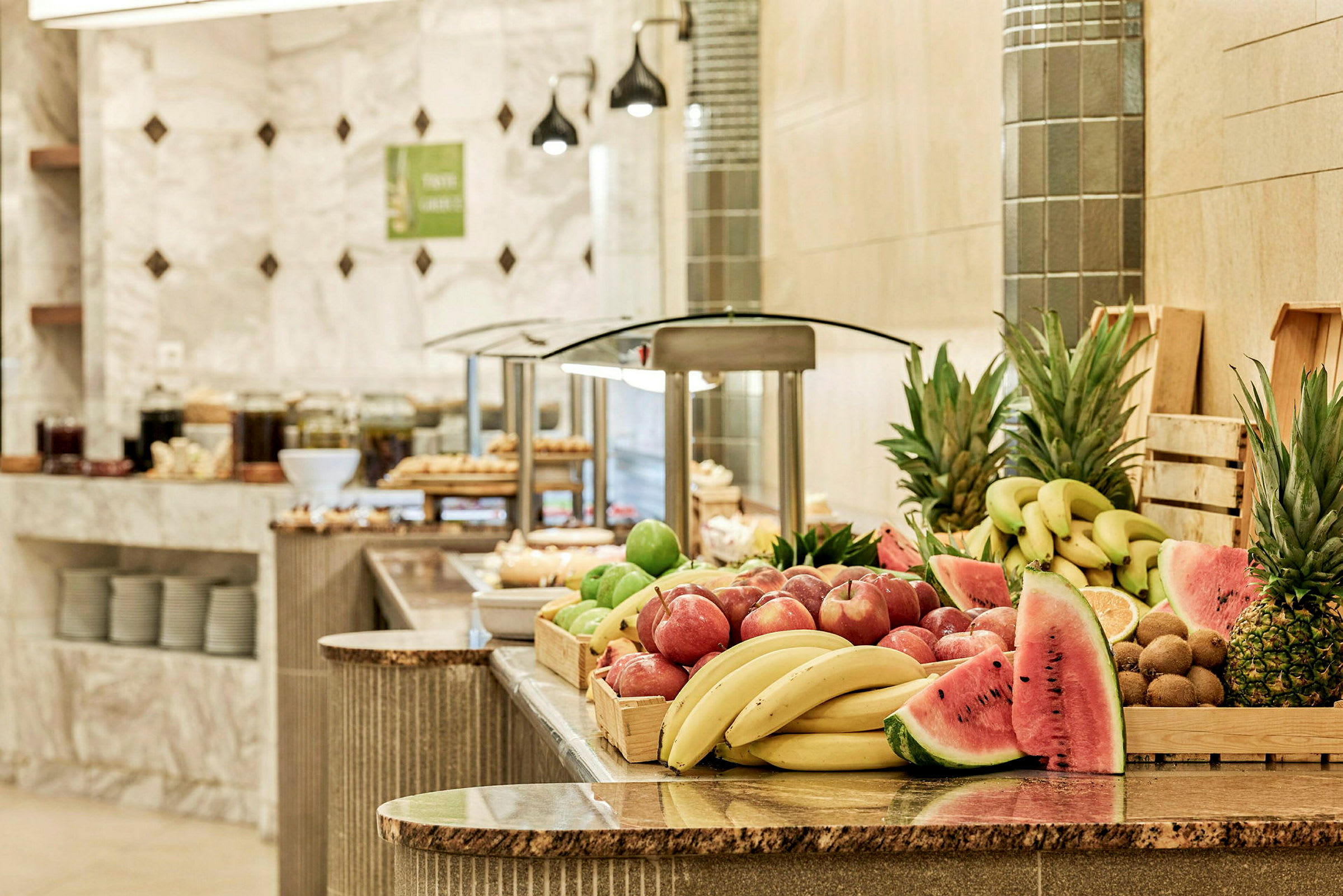 En buffé med fersk frukt inkludert bananer, epler, ananas og vannmelon. (AI-generert tekst)