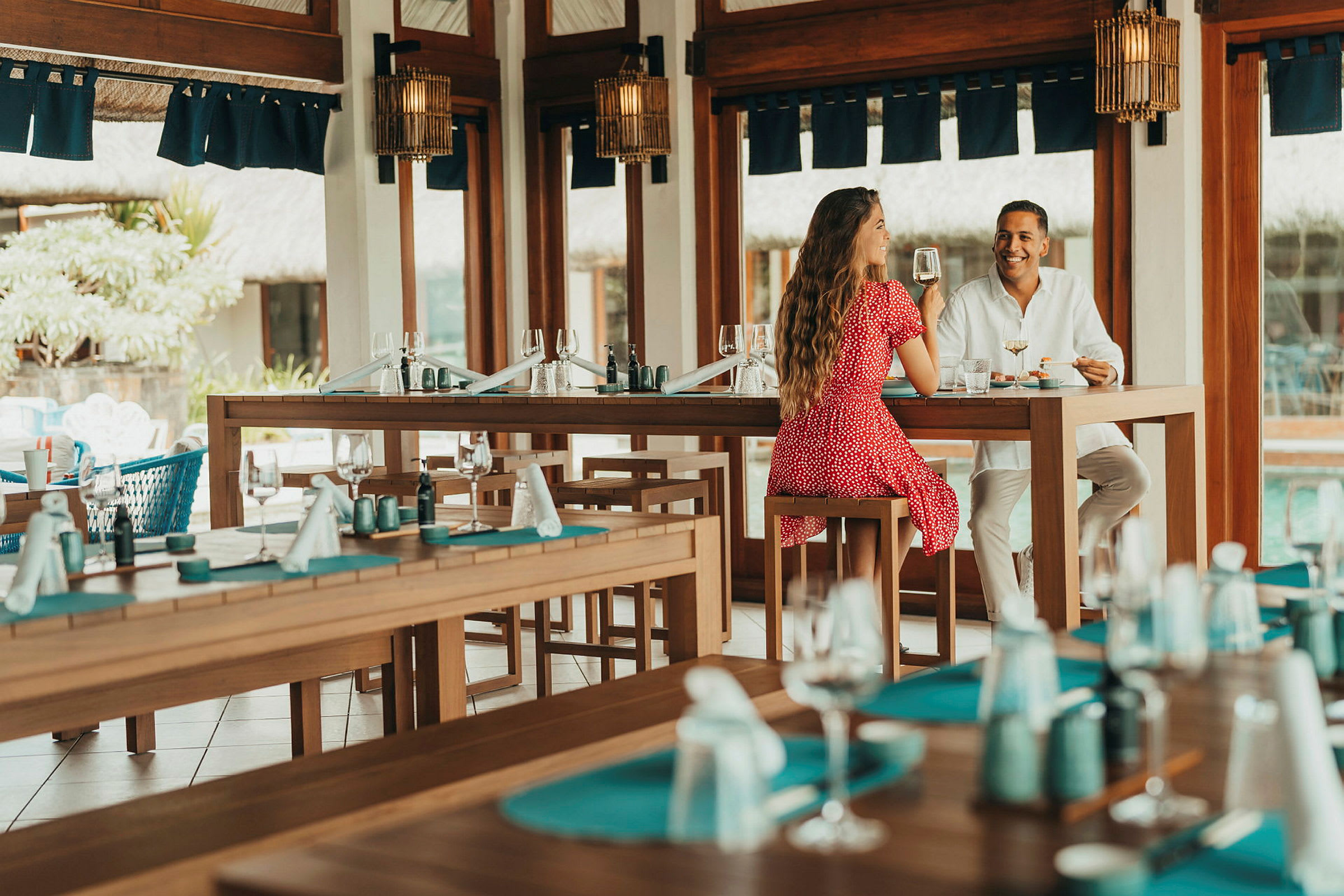 En restaurant med sittegrupper ved et bord. (AI-generert tekst)