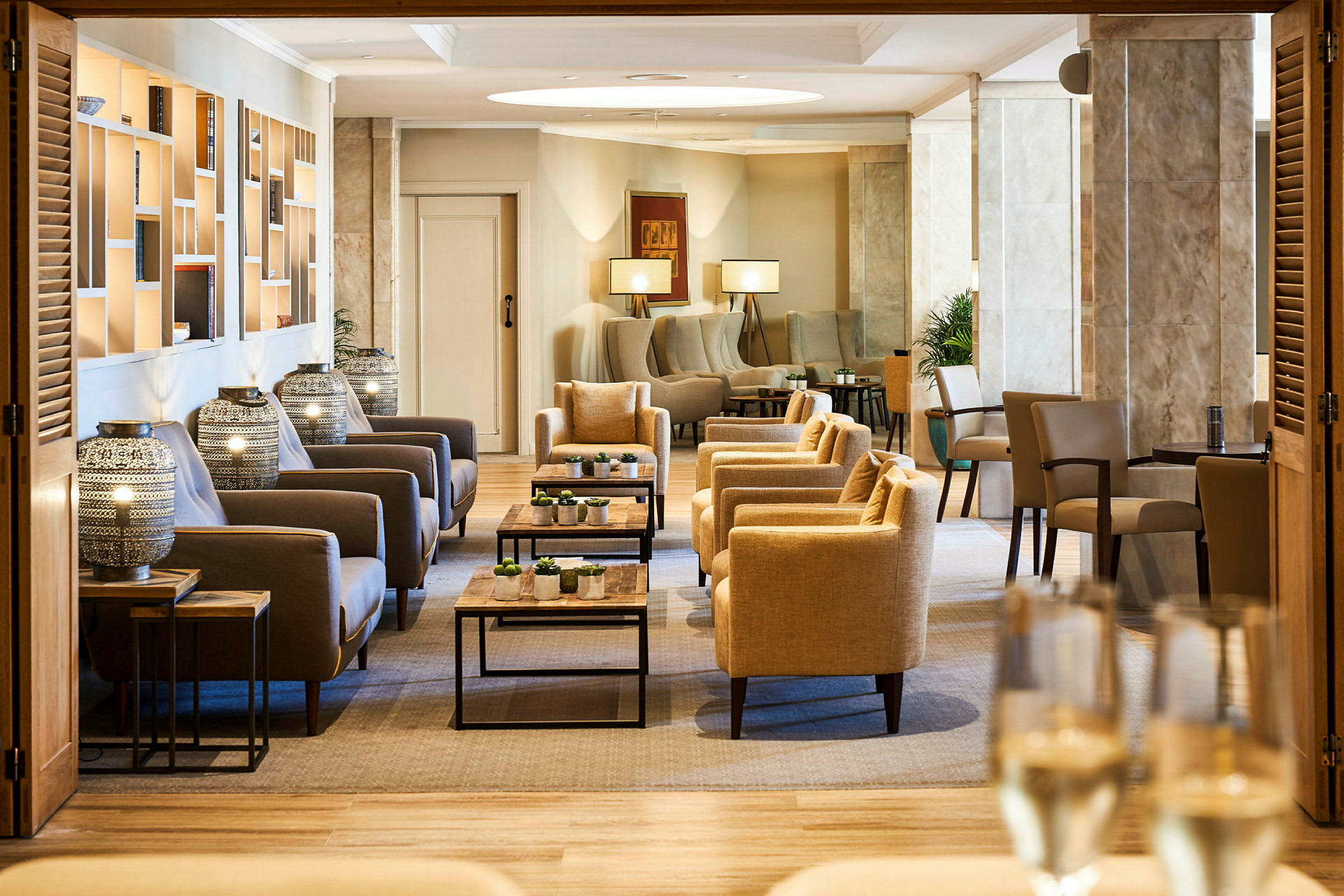 Et elegant loungeområde med beige og grå sittemøbler samt moderne dekorative elementer. (AI-generert tekst)