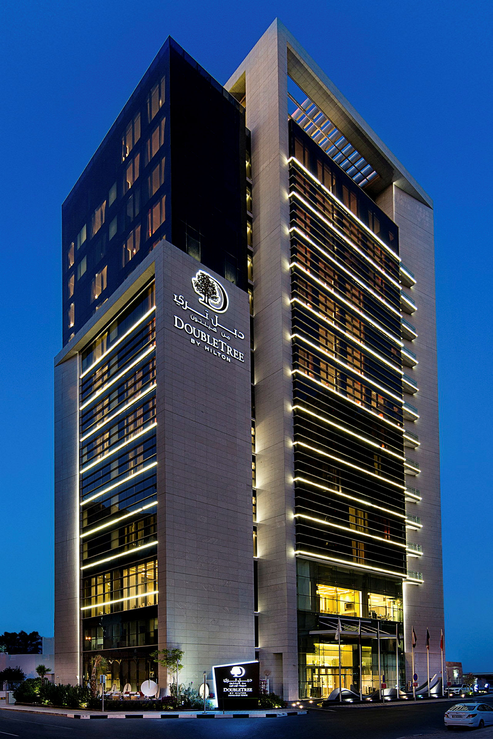 Bilde av et hotell med navnet DoubleTree by Hilton omgitt av blå himmel. (AI-generert tekst)